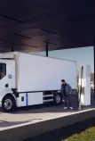 Man charging a Renault Trucks E-Tech D