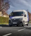 Renault Trucks E-Tech Master on the road in a city suburb