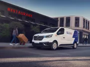 Trafic e-tech park on the street next to a restaurant and a person is walking to it