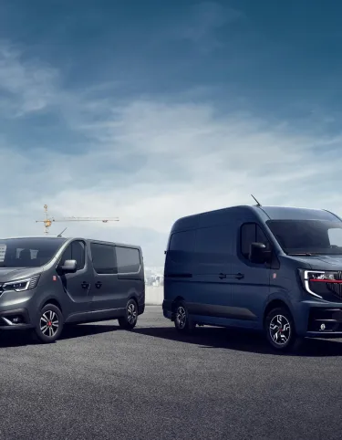 Renault Trucks Red Edition Exclusive range - Renault Trucks Trafic and Renault Trucks Master in front of a construction site backdrop on one side and a city backdrop on the other.